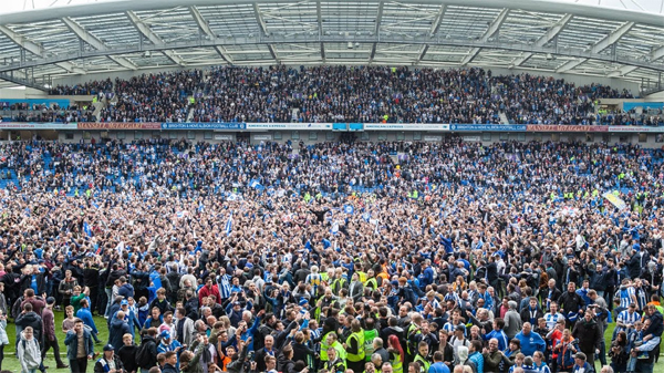 Brighton  beat Wigan Athletic to secure promotion to the Premier League