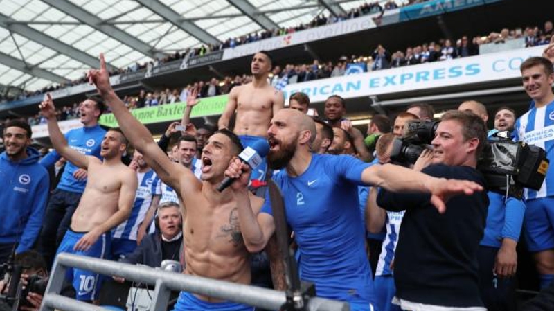 Brighton players celebrate promotion to the Premier League from the BBC Radio Sussex commentary position