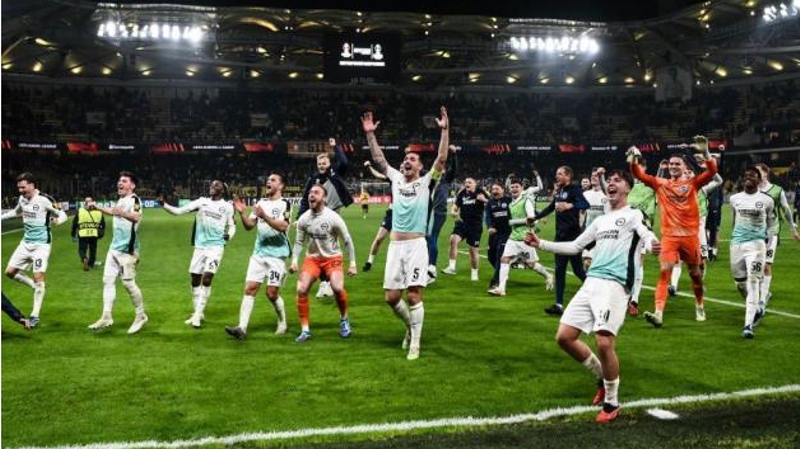 Brighton players celebrate their 1-0 win away against AEK Athens